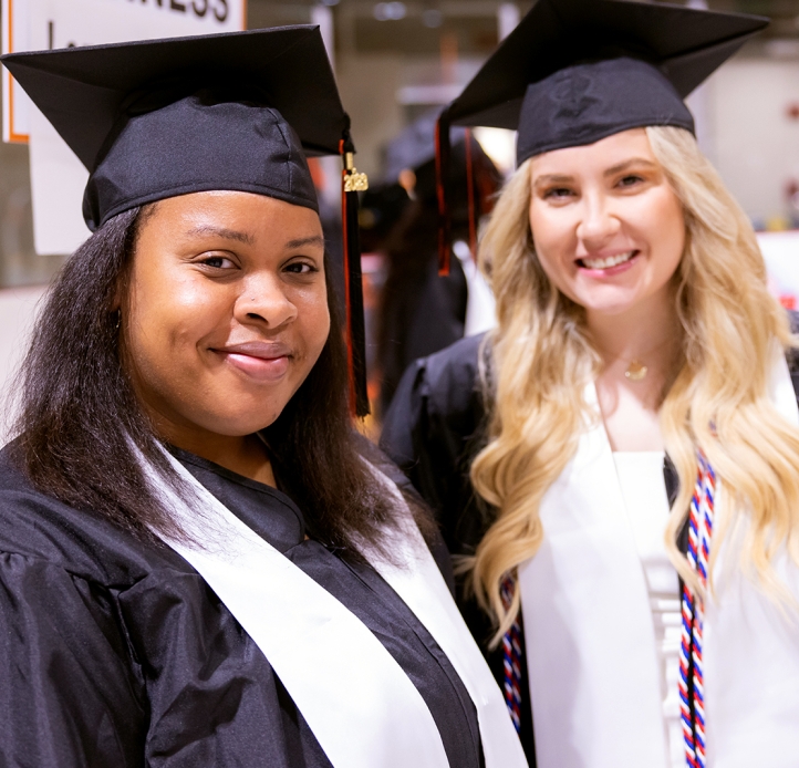 Two Commencement students smiling