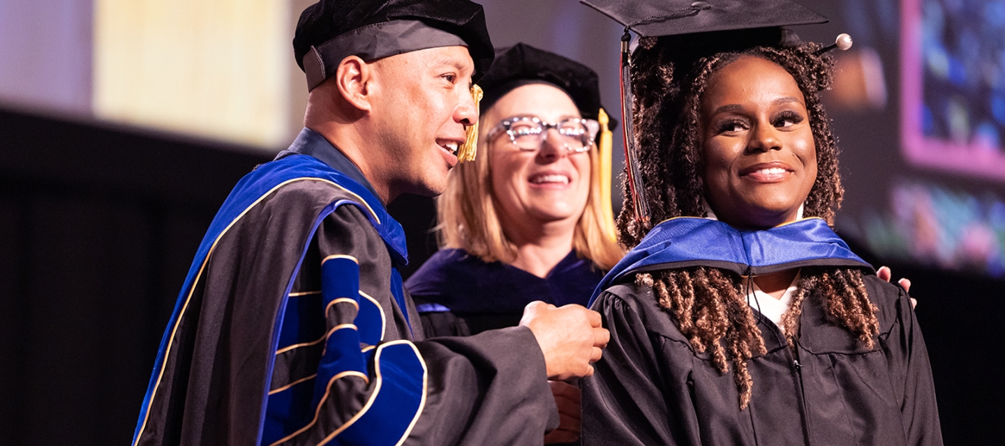 Commencement student with professors