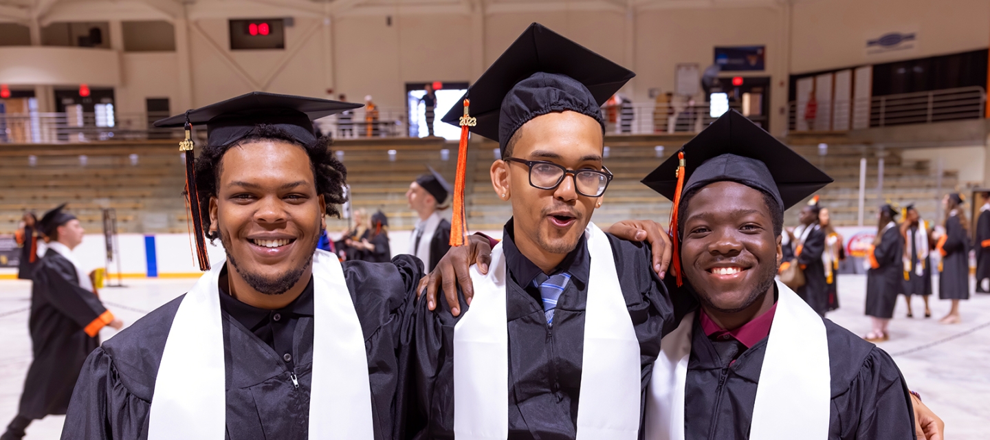 Three Commencement students smiling