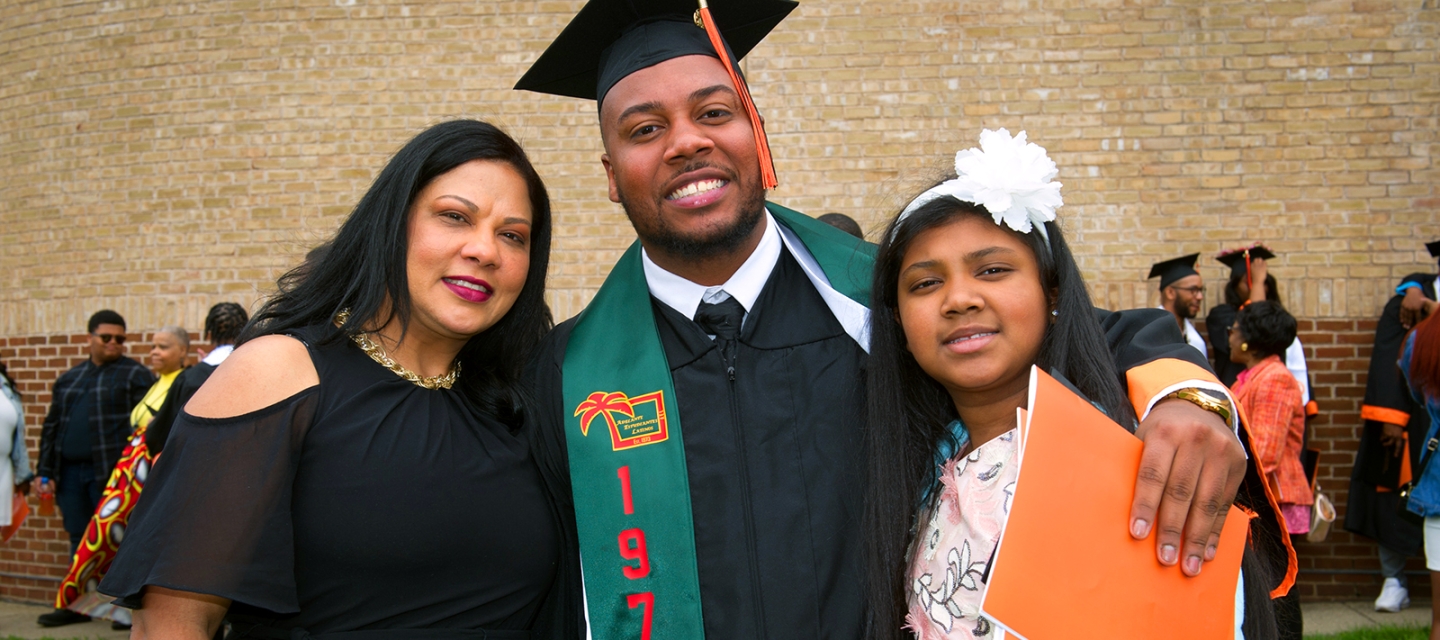 Family smiling outside
