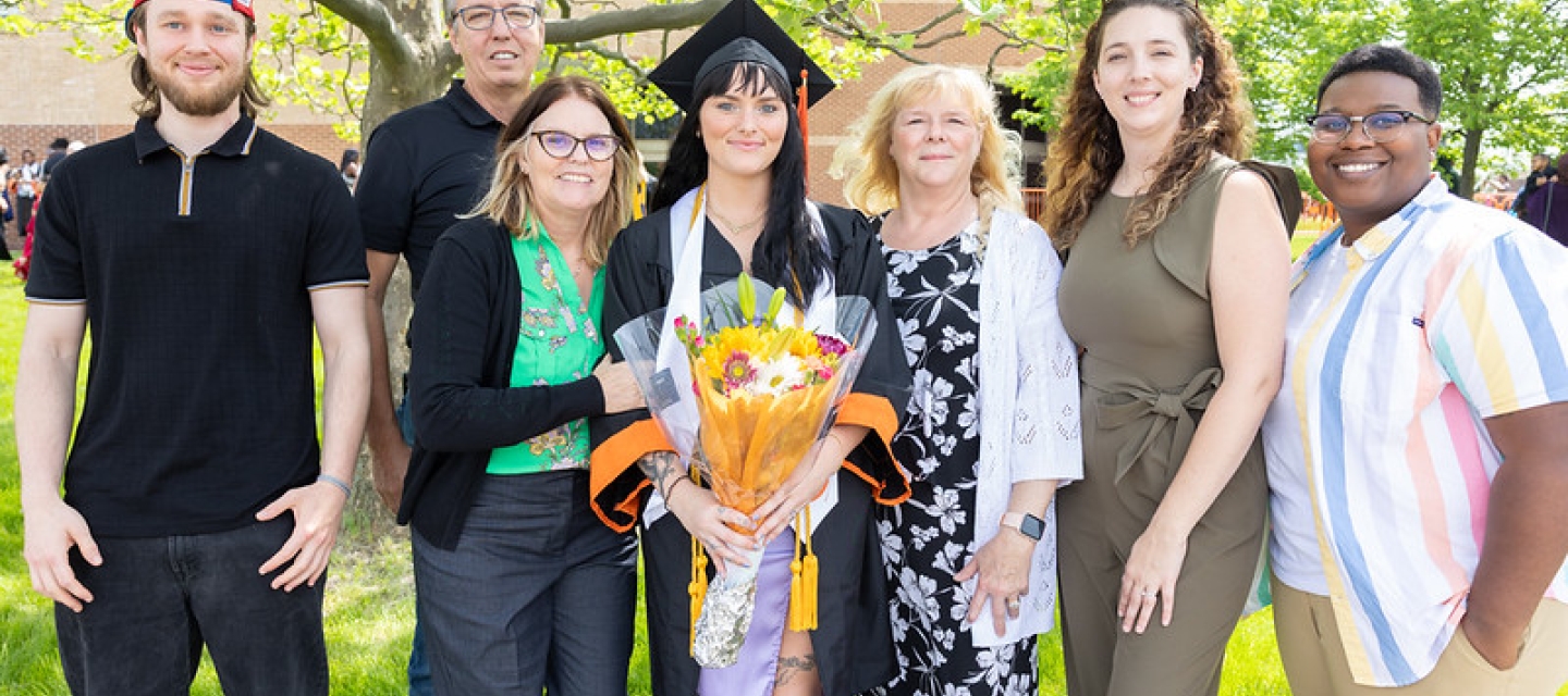 Graduate surrounded by family and friends